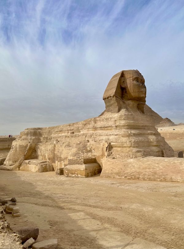 Majestic view of the Great Sphinx in Giza, showcasing ancient Egyptian architecture under a bright sky.