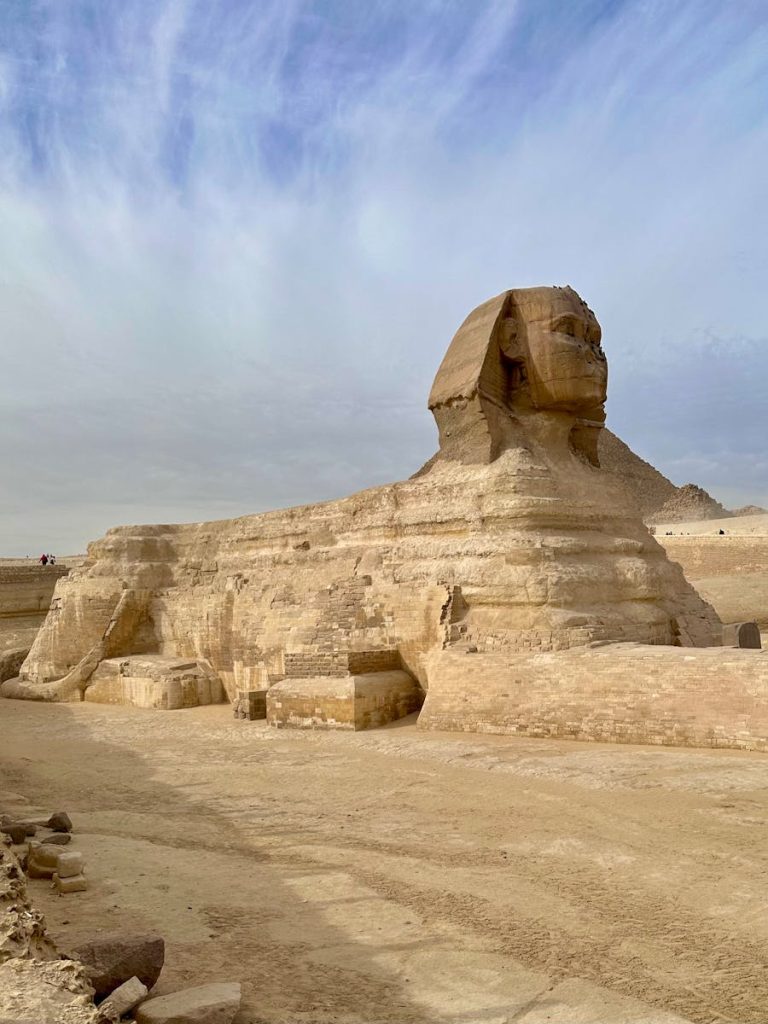 Majestic view of the Great Sphinx in Giza, showcasing ancient Egyptian architecture under a bright sky.